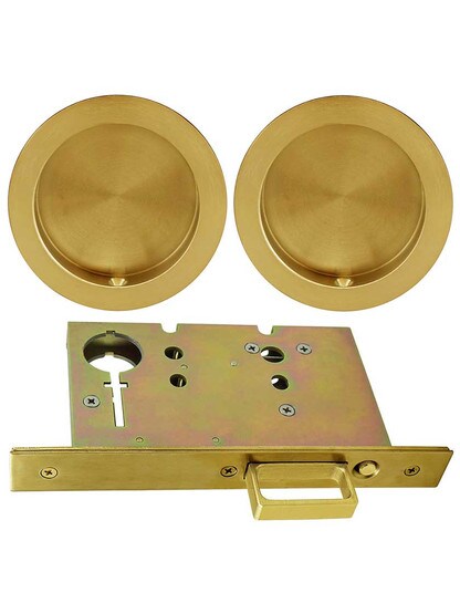 Premium Pocket-Door Mortise Lock Set with Round Pulls in Aged Brass.